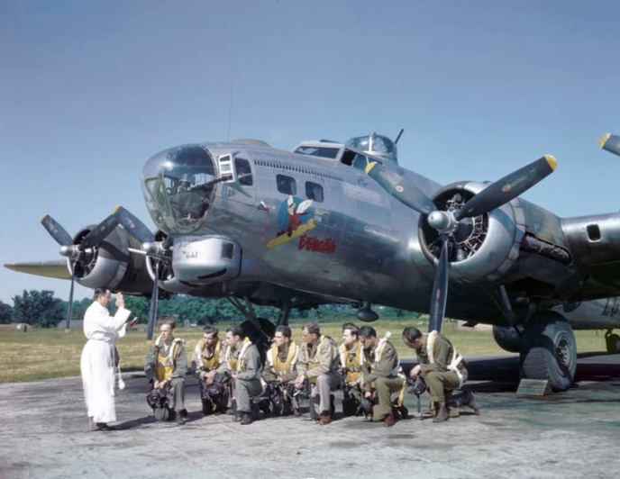Father Michael Ragan blesses the crew of the Boeing B-17G “Fifinella” before a mission in mid-1944.
